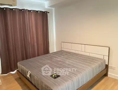 Cozy bedroom with modern bed and elegant curtains, perfect for relaxation.