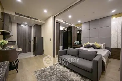 Modern studio apartment with open layout, featuring a cozy living area and stylish bedroom.