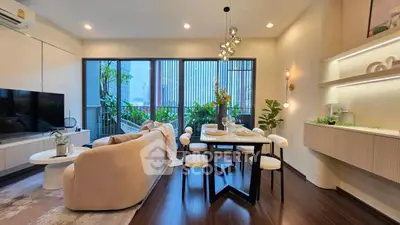 Modern living room with elegant decor and large windows overlooking a lush balcony.