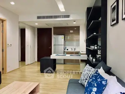 Modern open-layout living room with stylish kitchen and cozy seating area.