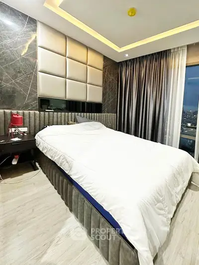Luxurious bedroom with modern design and city view, featuring elegant decor and ambient lighting.