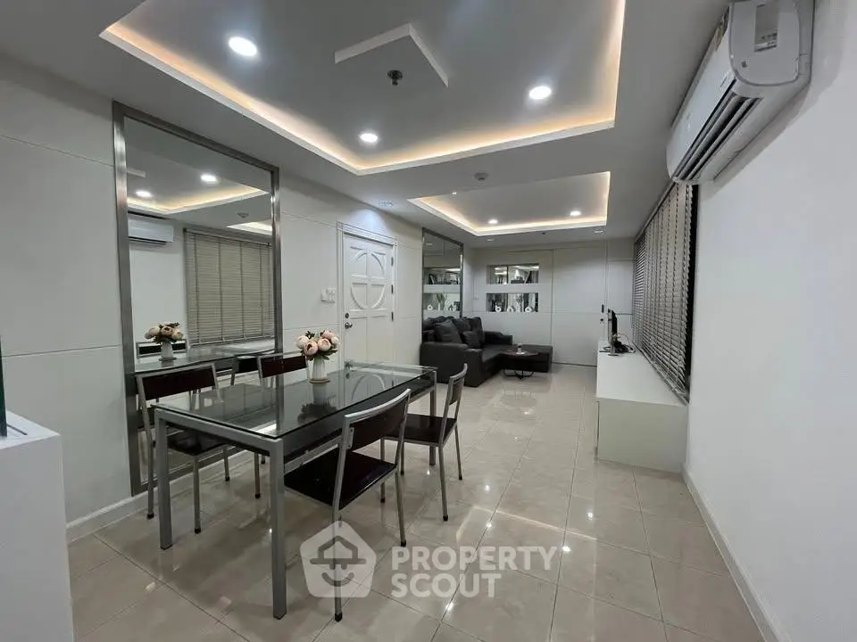 Modern living room with sleek dining area and stylish lighting