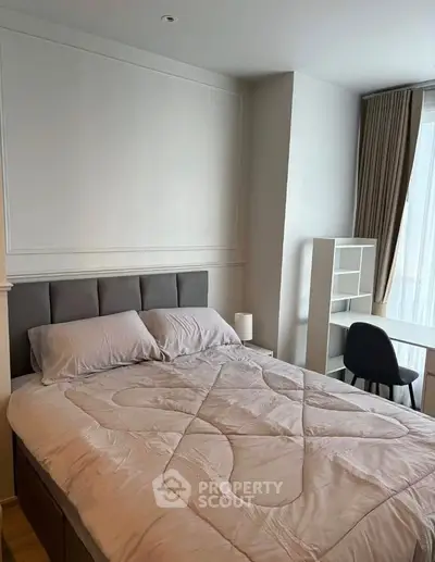 Modern bedroom with stylish decor and natural light, featuring a cozy bed and functional workspace.