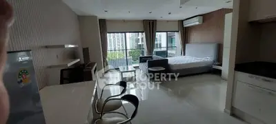 Spacious modern studio apartment with large windows and city view