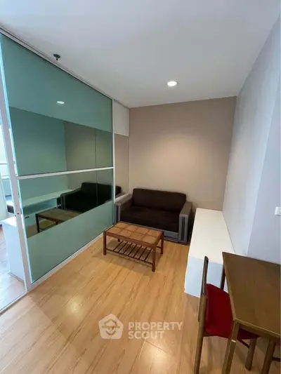 Cozy living room with modern furniture and wooden flooring in a stylish apartment.