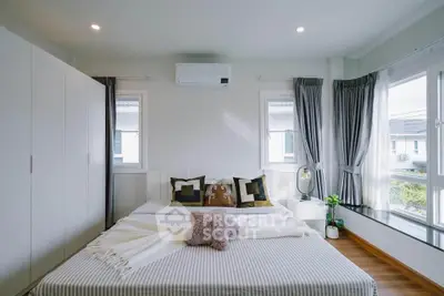 Modern bedroom with large windows and stylish decor