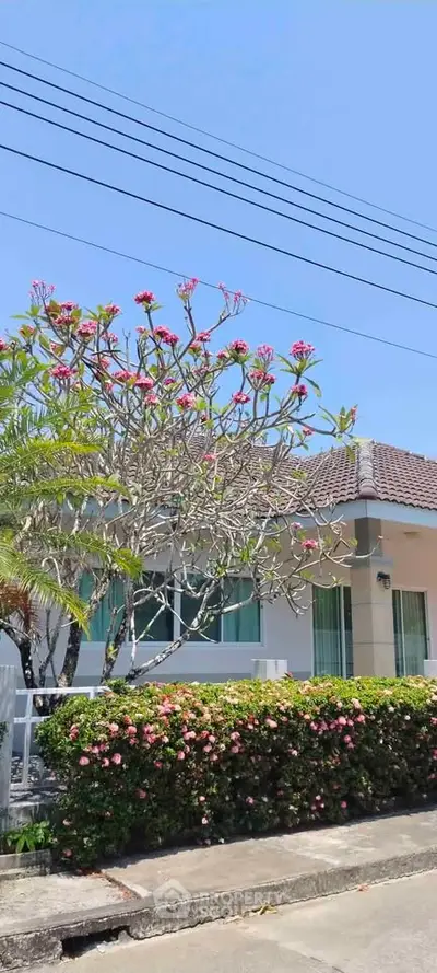 Charming suburban home with lush garden and blooming flowers, perfect for tranquil living.