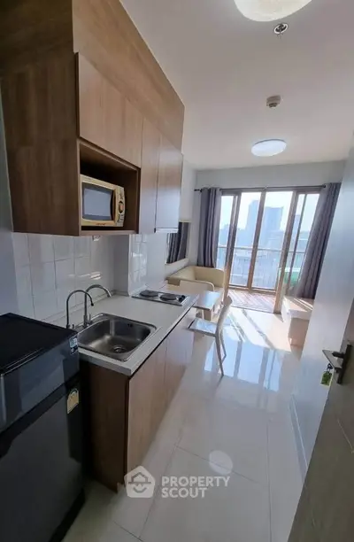 Modern apartment kitchen with open layout and city view balcony