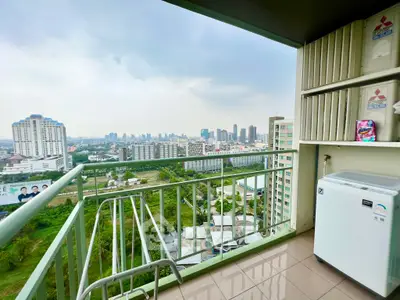 Stunning city view from a high-rise balcony with modern appliances.
