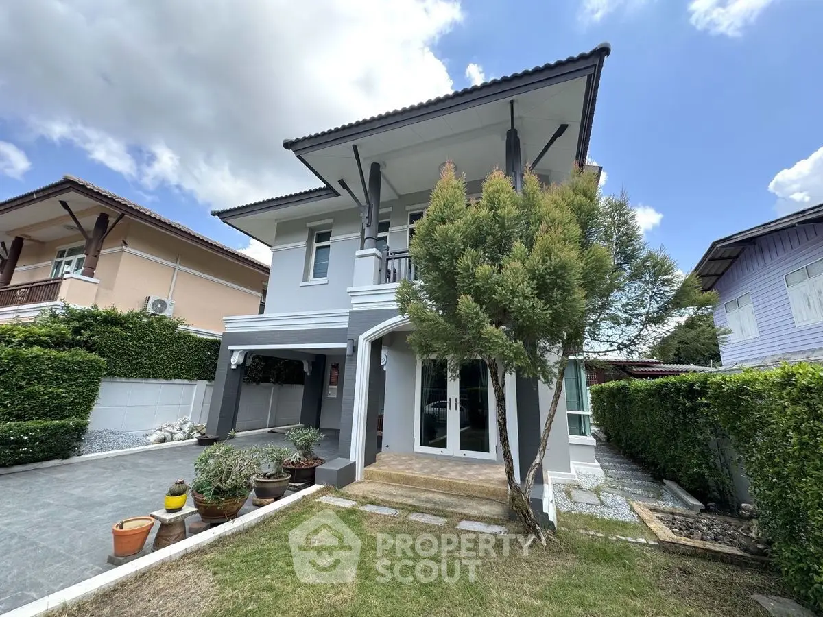 Charming two-story house with lush garden and modern exterior design, perfect for family living.