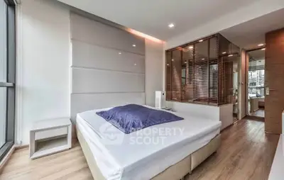 Modern bedroom with large windows and stylish decor in a luxury apartment.