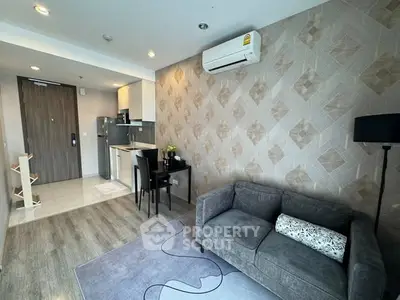 Modern living room with stylish decor and compact kitchen area