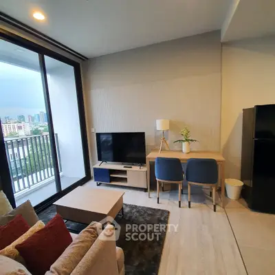 Modern living room with balcony view, stylish furniture, and natural light in urban apartment.