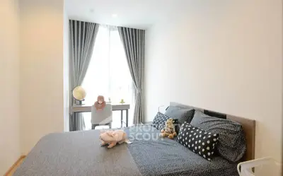 Cozy bedroom with stylish decor and ample natural light