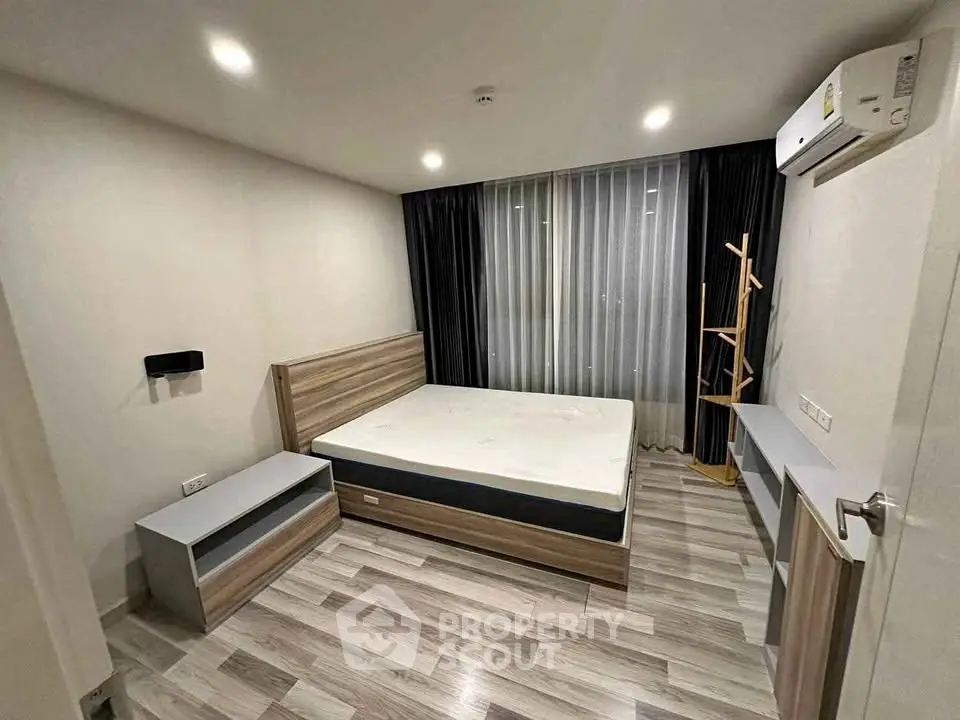 Modern bedroom with sleek design, featuring a comfortable bed, stylish furniture, and ambient lighting.