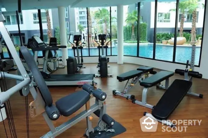 Modern gym with pool view in luxury residential complex