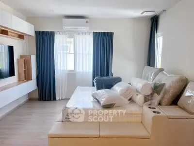 Modern living room with air conditioning and stylish furniture, perfect for comfortable living.