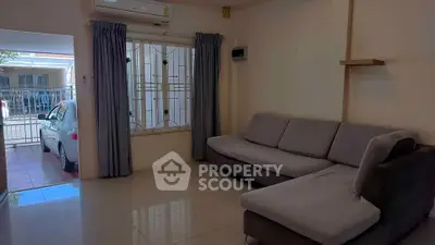 Spacious living room with modern sofa and large window view