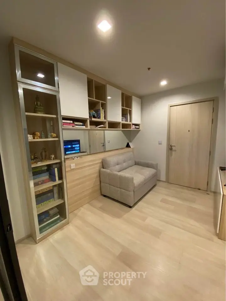 Modern living room with built-in shelving and cozy sofa, perfect for urban living.