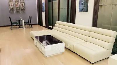 Spacious modern living room with elegant white sofa and sleek dining area