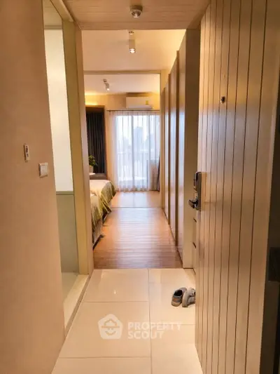 Modern bedroom entrance with wooden flooring and natural light