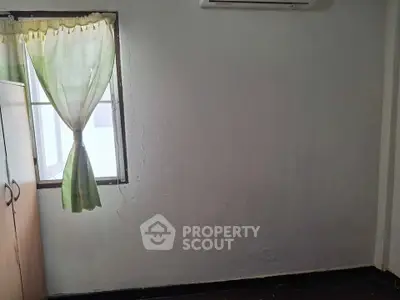 Minimalist room with window and air conditioning, ideal for cozy living space.
