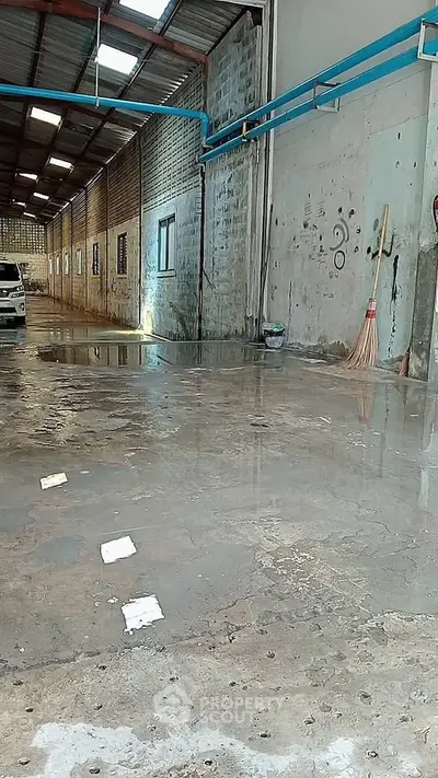 Spacious industrial warehouse with high ceilings and ample natural light.