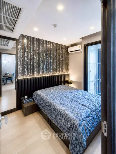 Modern bedroom with stylish decor and air conditioning in a contemporary apartment.