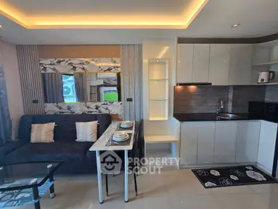 Modern open-plan living room and kitchen with sleek design and elegant decor.