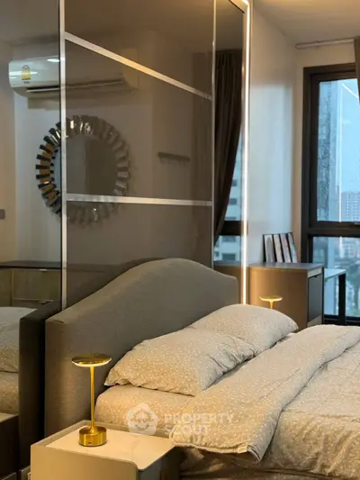 Modern bedroom with stylish decor and large window offering city views