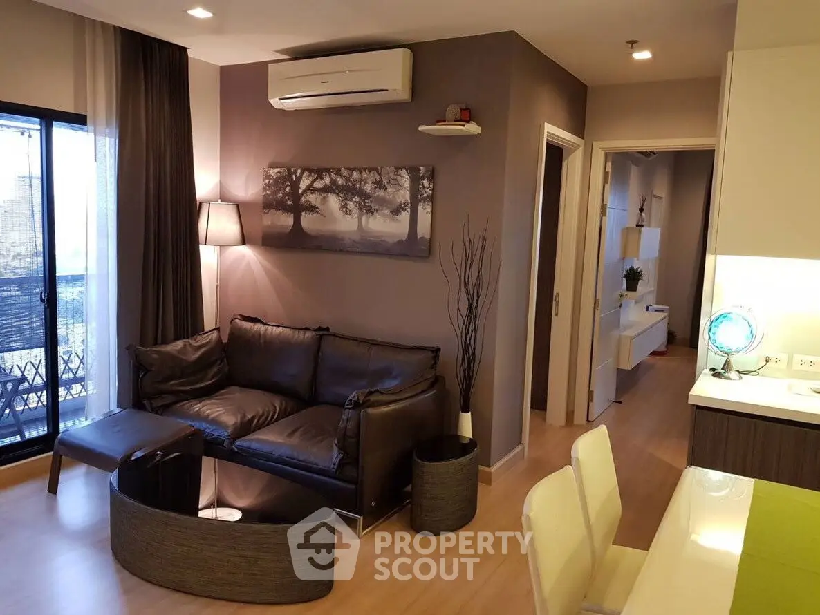 Modern living room with sleek furniture and stylish decor in a cozy apartment setting.