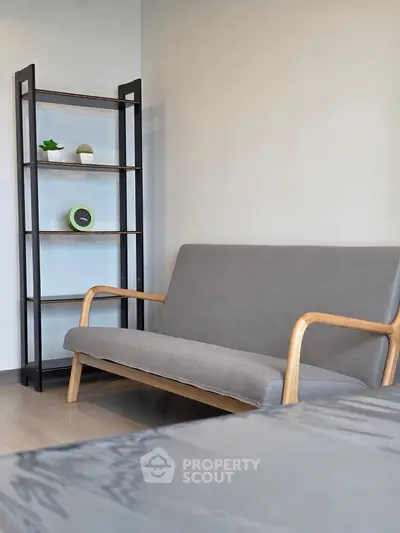 Modern living room with stylish gray sofa and sleek shelving unit