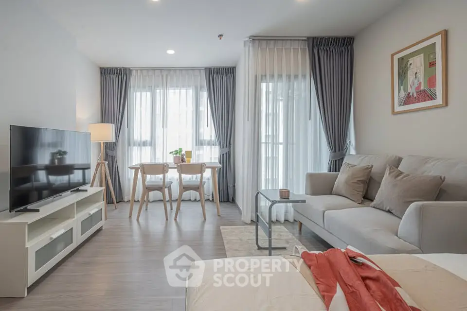 Modern living room with stylish decor, large windows, and cozy seating area in a contemporary apartment.