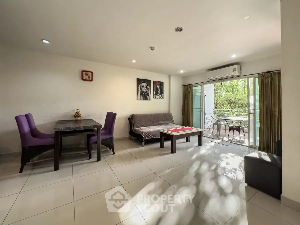 Spacious living room with modern decor and balcony access