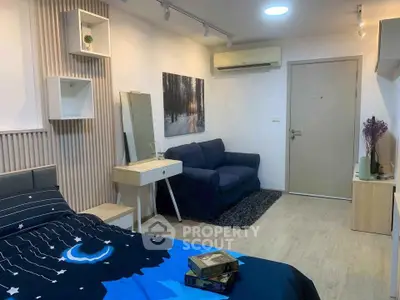 Cozy bedroom with modern decor and stylish furniture, featuring a comfortable bed and a small sofa.