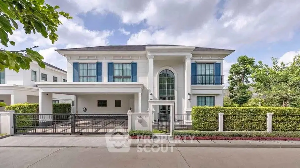 Luxurious two-story house with elegant facade and spacious driveway in a serene neighborhood.