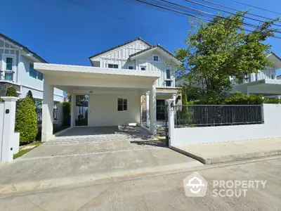 Charming modern house with spacious driveway and lush greenery in a serene neighborhood.