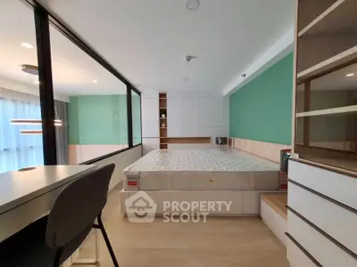 Modern bedroom with large window and stylish furniture in a contemporary apartment.