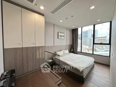Modern bedroom with city view and stylish wooden flooring