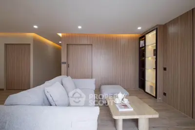 Modern living room with cozy sofa and elegant wooden paneling