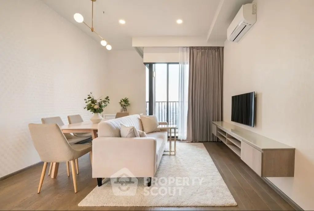 Modern living room with elegant decor, featuring a cozy sofa, dining area, and balcony access.
