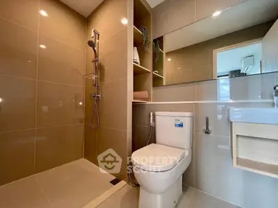 Modern bathroom with sleek shower and toilet in a stylish apartment.