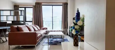 Spacious modern living room with city view, featuring elegant decor and large windows.
