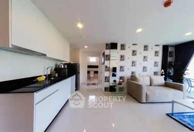 Modern open-plan living room with sleek kitchen and stylish decor