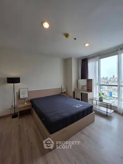 Modern bedroom with city view, featuring sleek wooden furniture and large windows for natural light.