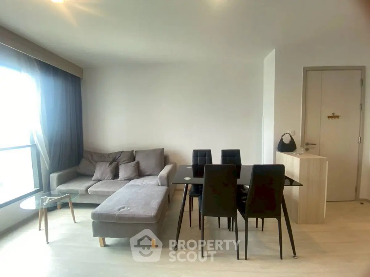 Modern living room with stylish furniture and dining area