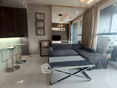 Modern living room with sleek furniture and large windows offering natural light.