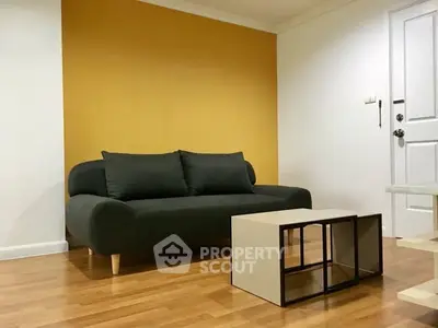 Modern living room with stylish sofa and minimalist coffee table on wooden flooring.