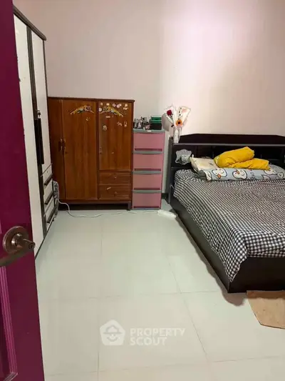 Cozy bedroom with checkered bedding and ample storage space