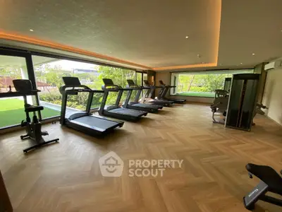 Luxurious modern gym with state-of-the-art equipment and garden view.